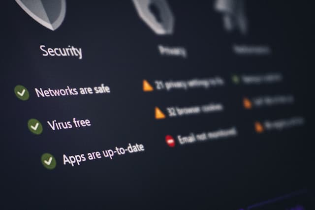 Close-up of a digital security dashboard showing privacy and system protection status including safe network, virus-free system, and updated apps indicators.